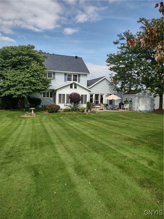 rear view of house featuring a lawn