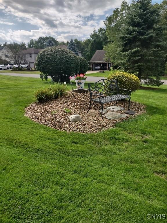 view of home's community with a yard