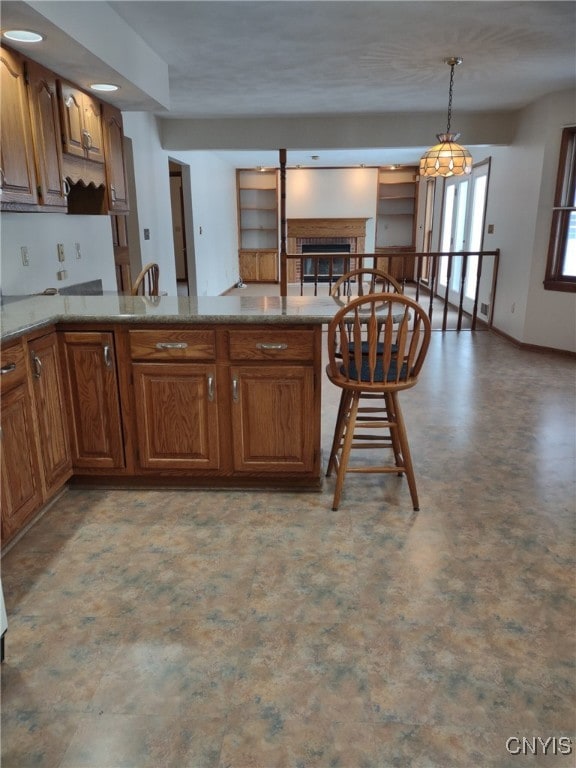 kitchen featuring kitchen peninsula and hanging light fixtures