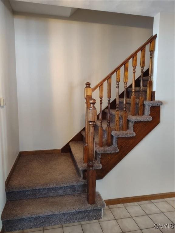 stairway with tile patterned floors