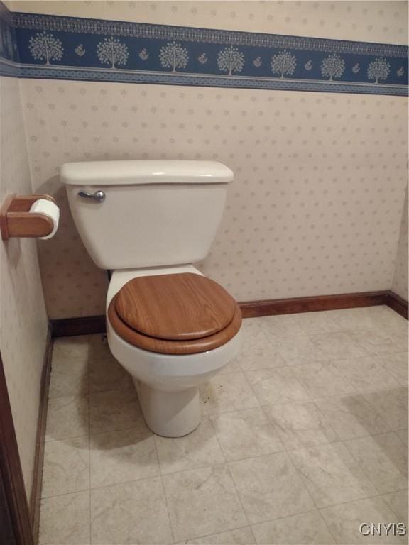 bathroom with tile patterned flooring and toilet