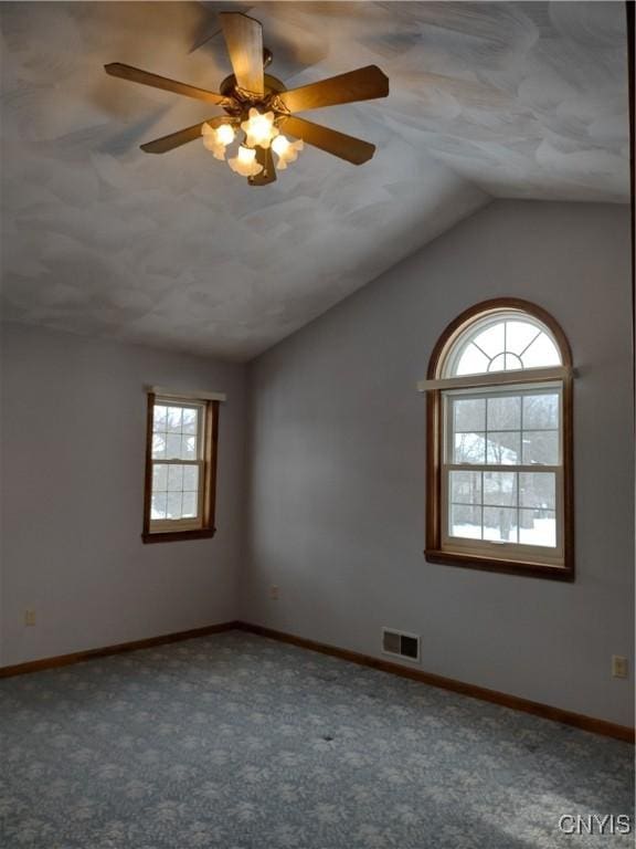 empty room featuring lofted ceiling and carpet