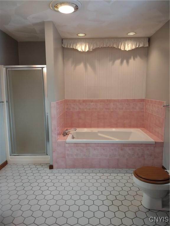 bathroom with tile patterned flooring, shower with separate bathtub, and toilet