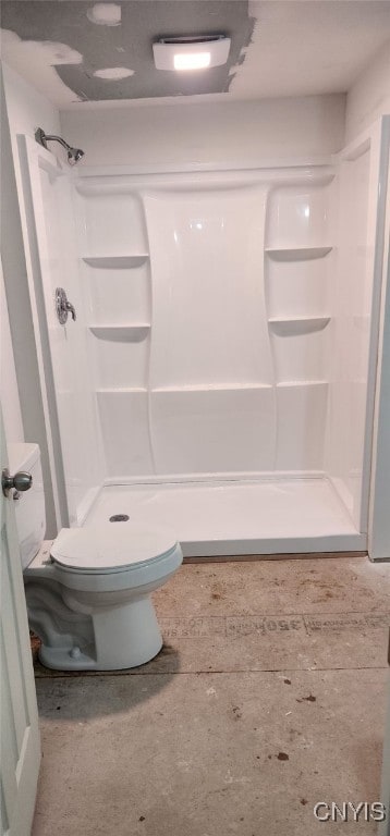 bathroom featuring toilet and walk in shower