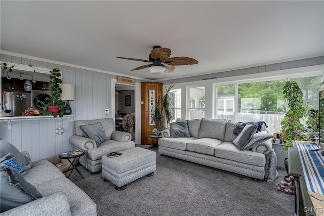 living room with ceiling fan and crown molding