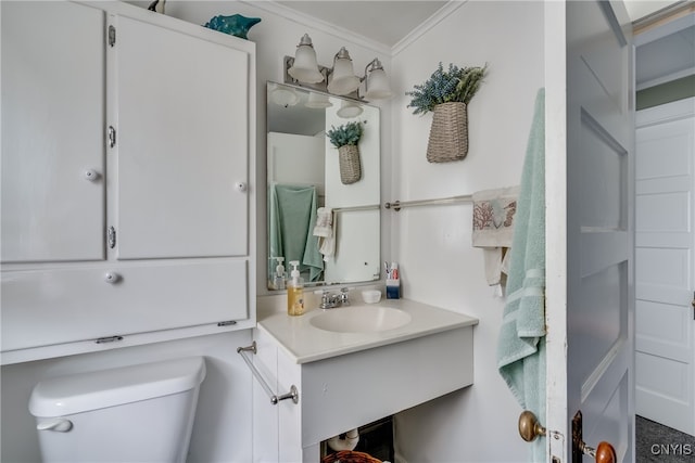 bathroom with sink, toilet, and crown molding