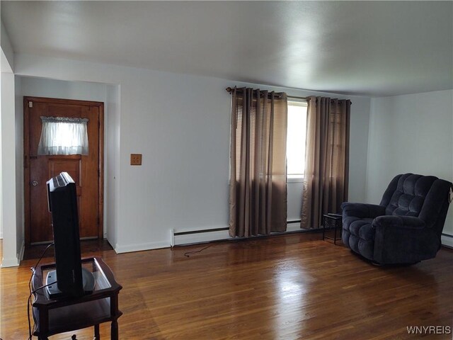 living area featuring a baseboard radiator and dark hardwood / wood-style flooring