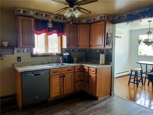 kitchen with dark wood-type flooring, black dishwasher, sink, hanging light fixtures, and a wall unit AC