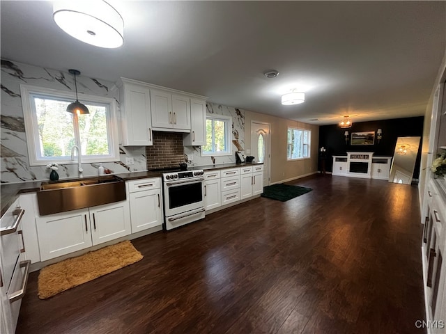 kitchen with white cabinets, sink, dark hardwood / wood-style floors, range with electric cooktop, and pendant lighting