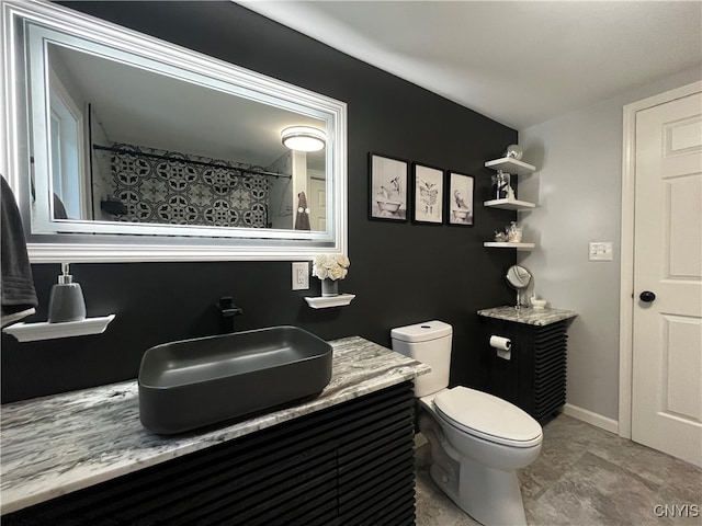 bathroom with a shower with shower curtain, toilet, and vanity