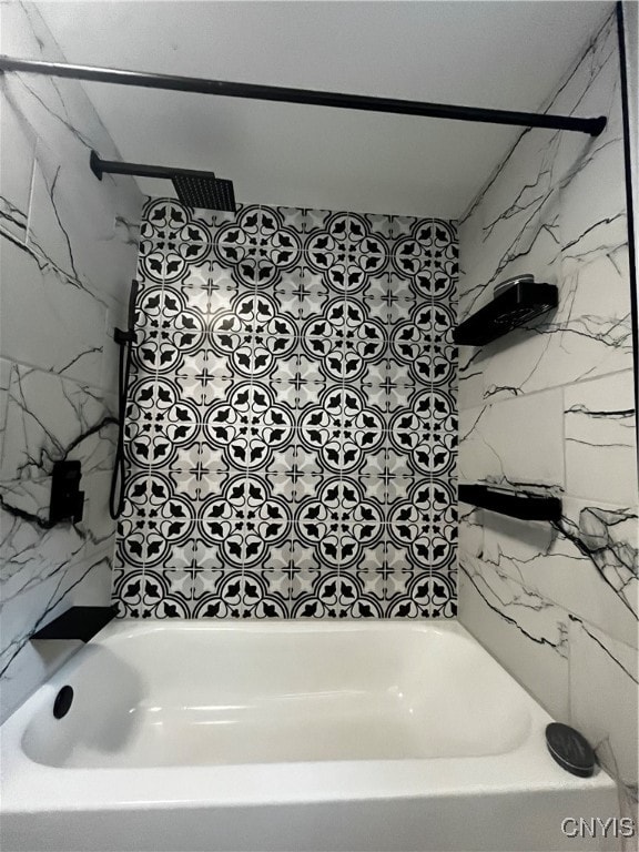 bathroom featuring tiled shower / bath combo and tile walls