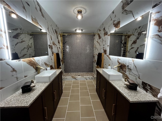 bathroom with tile walls, a tile shower, and vanity