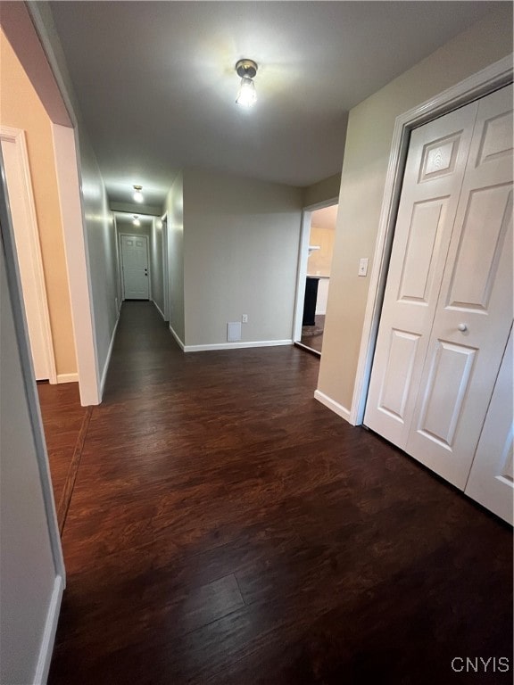 corridor with dark wood-type flooring