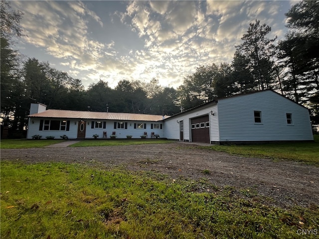 view of front of home featuring a garage and a yard