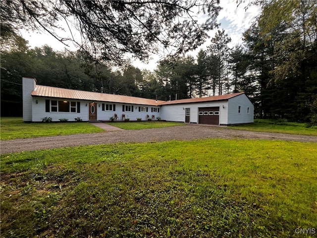 ranch-style home featuring a garage and a front lawn