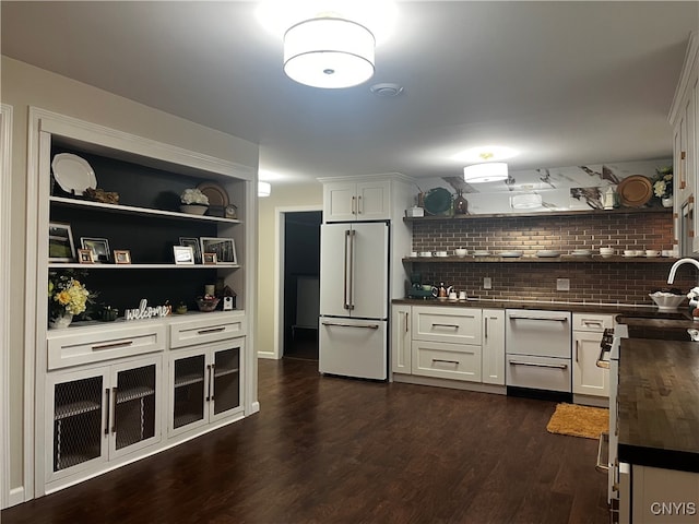 kitchen with white cabinetry, dark hardwood / wood-style flooring, high end white refrigerator, and wood counters