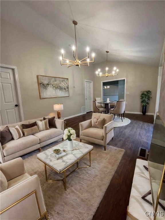 living room featuring lofted ceiling, dark wood-type flooring, and an inviting chandelier