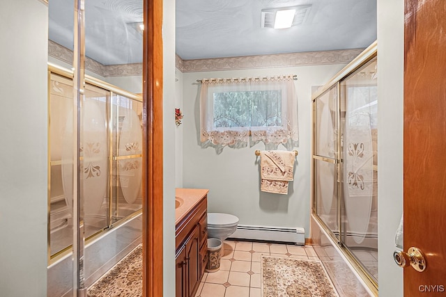 full bathroom featuring baseboard heating, vanity, enclosed tub / shower combo, and toilet