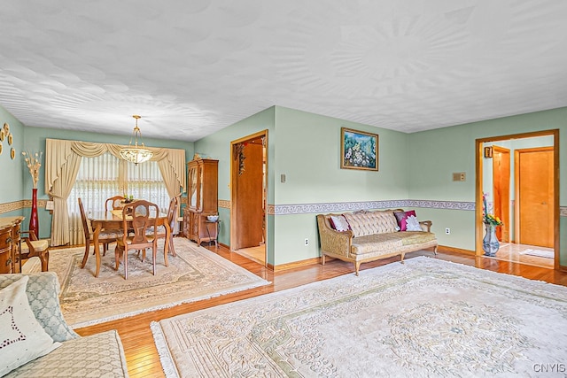 dining space featuring an inviting chandelier and light hardwood / wood-style flooring