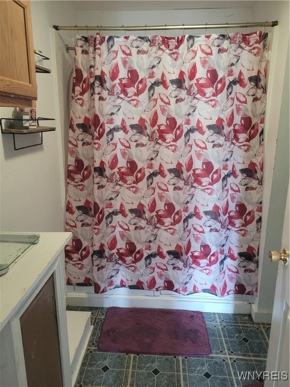 bathroom with vanity, tile patterned flooring, and curtained shower