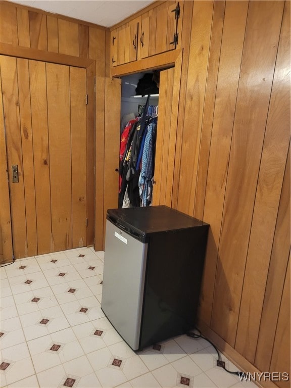 mudroom featuring wooden walls