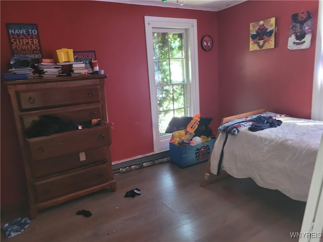 bedroom featuring hardwood / wood-style flooring and crown molding