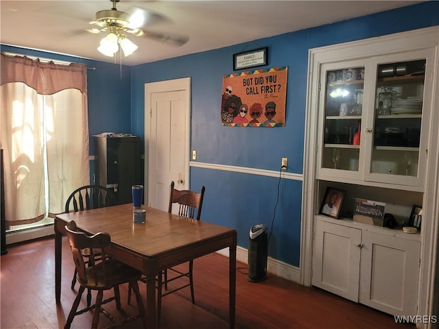 dining space with baseboard heating, ceiling fan, and dark hardwood / wood-style flooring