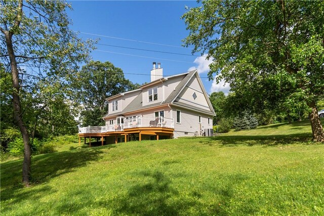 15043 State Route 54th Rd, Wayne, NY 14837 - back of property with a wooden deck, a lawn, a chimney, and central AC unit