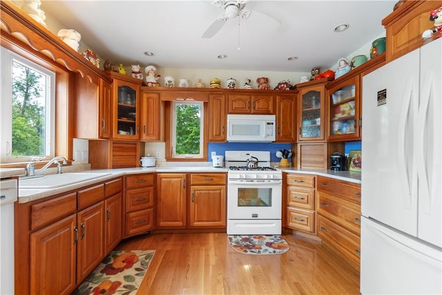 15043 State Route 54th Rd, Wayne, NY 14837 - kitchen featuring white appliances, a sink, light countertops, light wood-style floors, and brown cabinets