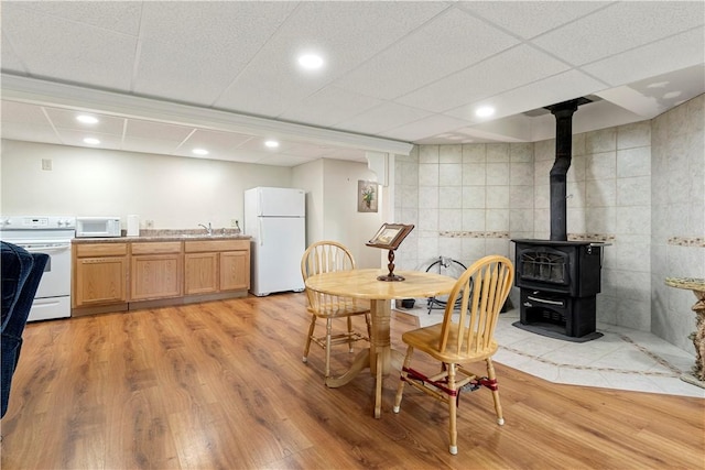 15043 State Route 54th Rd, Wayne, NY 14837 - dining area with light wood finished floors, a wood stove, tile walls, and recessed lighting