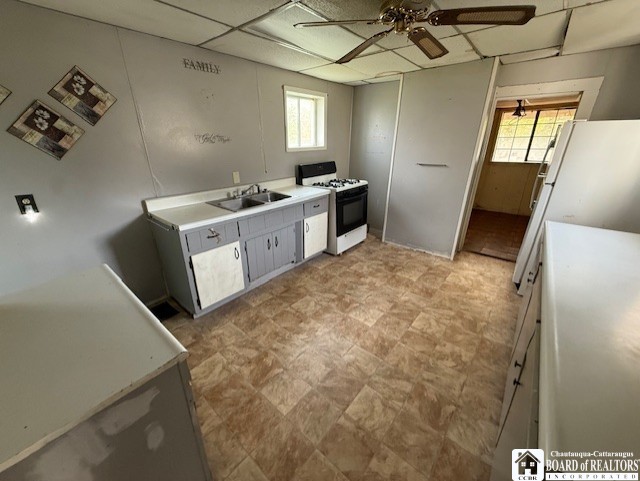 512 N 7th St, Olean-City, NY 14760 - kitchen with a sink, ceiling fan, white range with gas stovetop, and light countertops