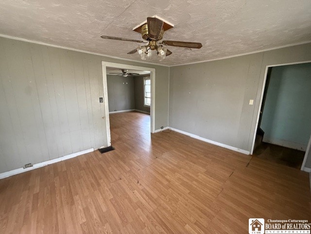 512 N 7th St, Olean-City, NY 14760 - unfurnished room featuring a textured ceiling, a ceiling fan, baseboards, wood finished floors, and ornamental molding