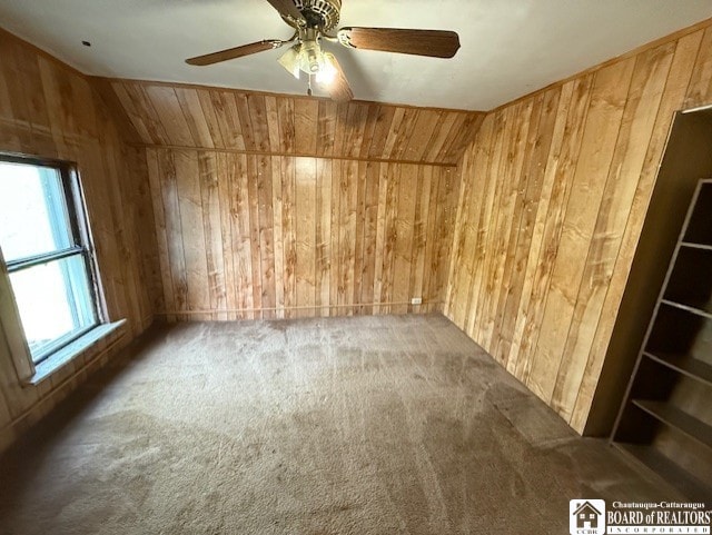 512 N 7th St, Olean-City, NY 14760 - carpeted spare room with wood walls and ceiling fan