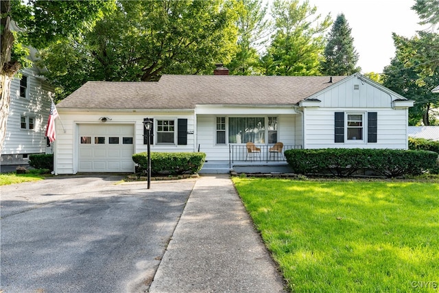 ranch-style home featuring a garage and a front lawn