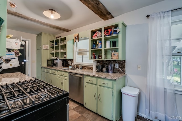 kitchen featuring beamed ceiling, stainless steel dishwasher, sink, and a healthy amount of sunlight