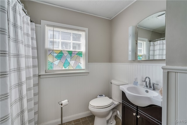 bathroom with toilet, vanity, and tile patterned floors