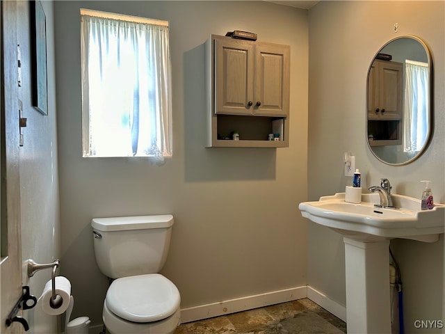 bathroom featuring sink, toilet, and tile patterned flooring