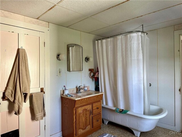 bathroom with shower / bath combo, a paneled ceiling, and vanity