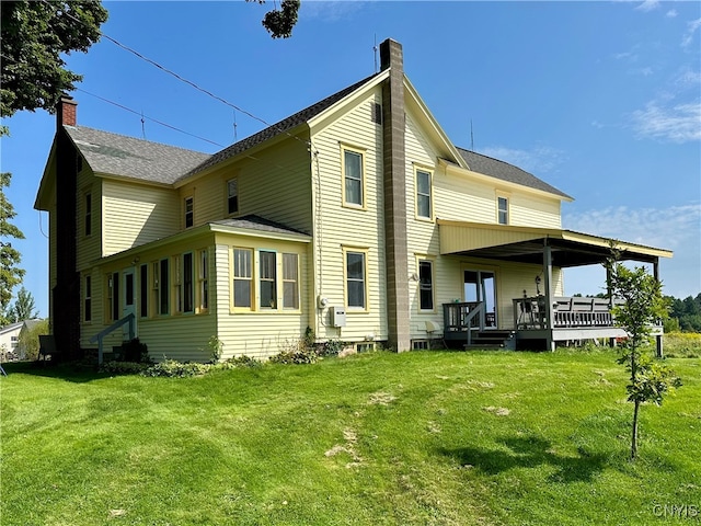 rear view of house with a yard