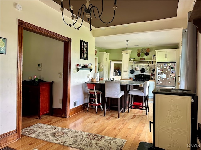 dining area with sink and light hardwood / wood-style flooring