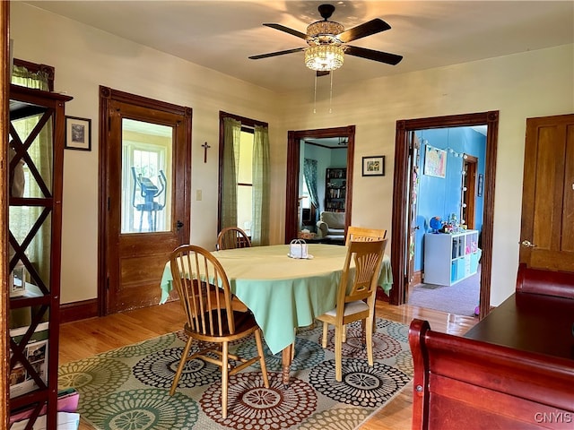 dining space featuring ceiling fan and light hardwood / wood-style flooring