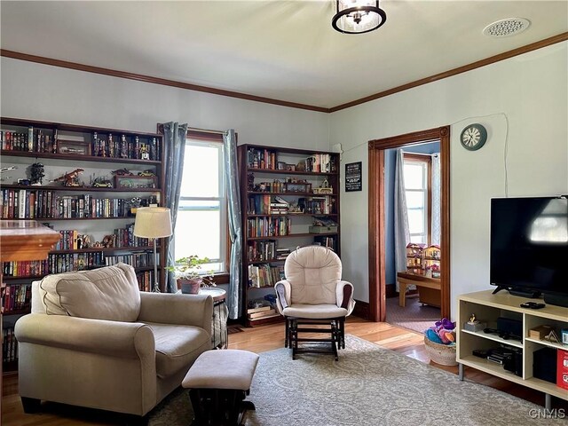 living room featuring hardwood / wood-style floors and ornamental molding