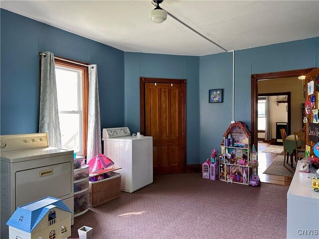 playroom with carpet flooring, plenty of natural light, and separate washer and dryer