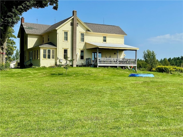 rear view of property with a lawn