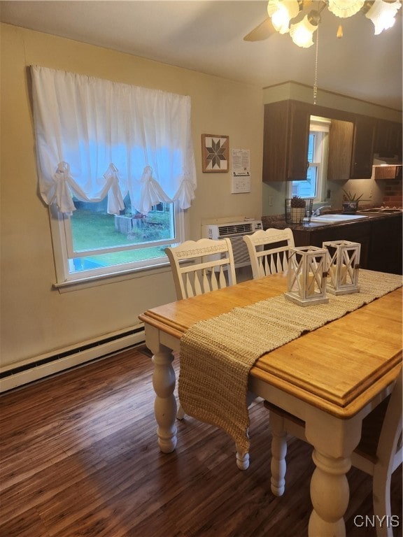 dining space with a wealth of natural light, hardwood / wood-style flooring, sink, and ceiling fan