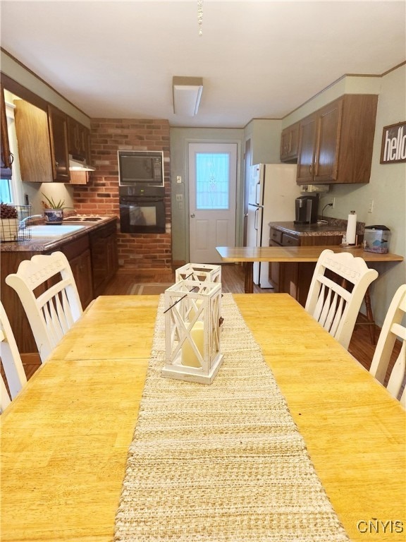 dining room with light wood-type flooring and sink