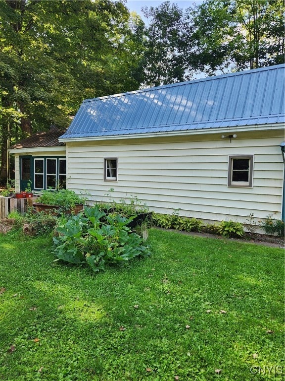 view of side of property with a yard