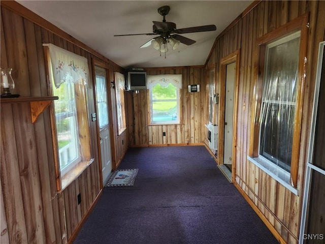 interior space with heating unit, lofted ceiling, and ceiling fan