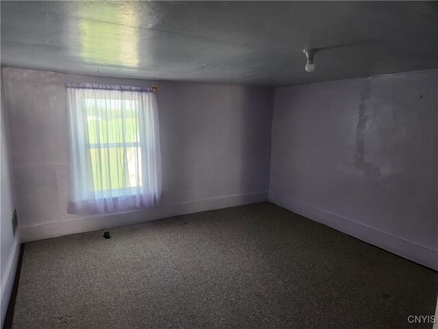 spare room with baseboards