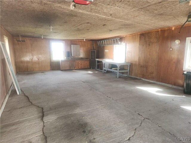 misc room with concrete floors and wood walls
